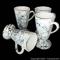 Group view of all four white and gray marble ceramic mugs