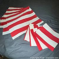 Stack of red and white striped linen placemats spread out