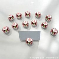 All 12 ceramic owl place card holders arranged with sample card