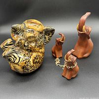 Group shot of ceramic elephant and three wood elephants with chain