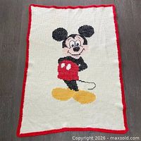 Full view of knitted Mickey Mouse blanket showing size and design