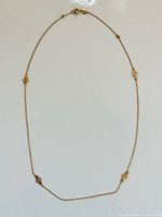 Full view of 14K gold necklace laid flat