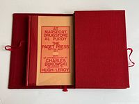 Book in open red slipcase showing fit and ribbon ties