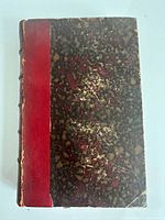 Front cover showing red leather spine and marbled boards