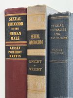 Spines of the three hardcover books showing titles and authors