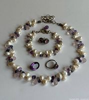 Group shot of necklace, bracelet, ring, brooch and earrings