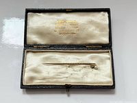 Stick pin in open case showing overall length and presentation