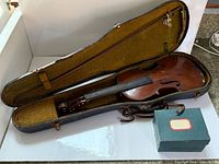 Violin inside hard case with accessory box