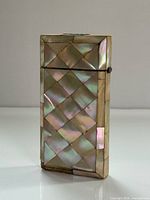 front view of mother of pearl cigar case showing checker pattern