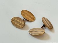 Top view of both cufflinks showing patterned faces