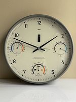 Front view of Bai weather station wall clock displaying main and sub-dials