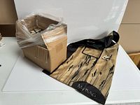 Box with plastic wrap and one unfolded bag showing full design