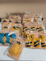 Group of sealed loofah scrubbers in assorted shapes on table