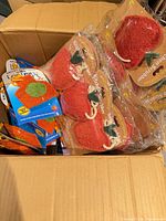 Box filled with packaged strawberry and lantern loofah scrubbers