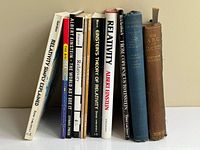 Lineup of eight Einstein and relativity books standing upright