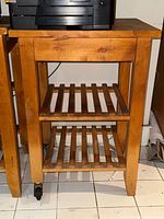 Front view showing trolley structure, shelves and casters