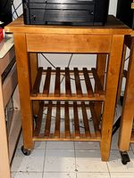 Full view of IKEA BEKVÄM trolley showing top, shelves, and casters