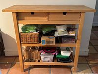 Front view showing top, drawers, shelves, contents excluded