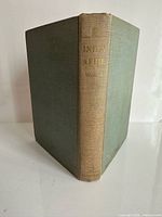 Front and spine view of green cloth hardcover book