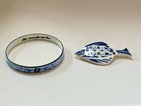 Bangle and fish brooch side by side