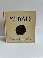 Front cover showing title, medal image and cloth boards