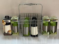 Group shot of four boxed mills, four loose mills and metal basket