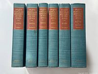 Six volumes upright showing spines