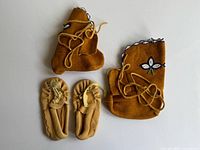 Both pairs of moccasins side by side showing styles and beadwork