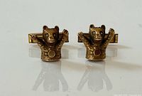 Front view of both bear cufflinks showing form and diamond eyes