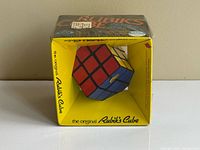 Front view of sealed Rubik’s Cube in yellow window box