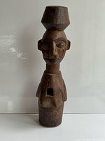 Front view of carved wood bust showing full form and headpiece