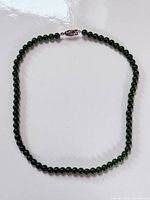 Full view of jade bead necklace closed in loop