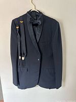 Full view of tuxedo jacket with bow tie and suspenders