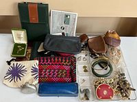 Overview of lot showing jewellery trays, pouches, cases, and accessories