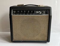 Front view showing grille, control knobs, branding