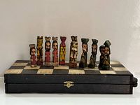 Closed folding chess board with several pieces displayed