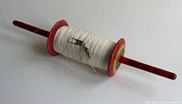Full view of spool showing painted ends and string