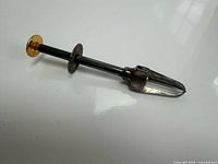 Full view of grabber showing jaws and shaft