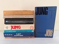 Group shot of all eight psychology paperback books, stacked with one standing