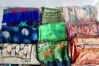 Eight textiles laid out showing patterns and colours