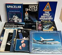 Group shot of entire lot showing all books, binder, laserdisc and pamphlets