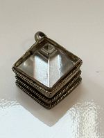 Front view of square sterling pendant showing clear crystal pyramid prism and rope trim