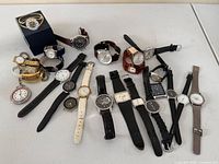 Group shot of entire lot showing all wristwatches laid out, including Nautica watch in box