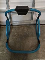 Front view of teal ab rocker frame with padded headrest