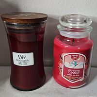 Front view of both candles showing brands and labels