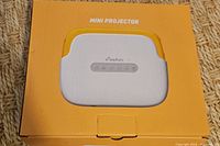Top of orange Elephas box showing Mini Projector branding