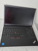 Laptop open showing screen, keyboard, trackpoint and Intel Core sticker