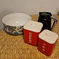 Group with floral bowl, coffee carafe and red canisters