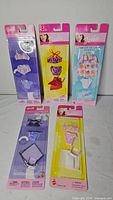 Front view showing all five sealed Barbie fashion packs