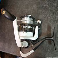 Overall view of Ugly Stik spinning reel showing body, handle and spool